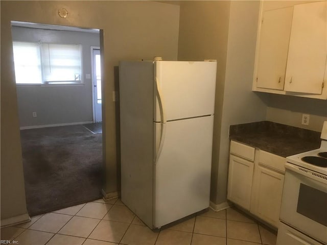 3227 Vimy Ridge Ave, Norfolk, VA 23509 - kitchen featuring white appliances, dark countertops, baseboards, white cabinetry, and light tile patterned floors