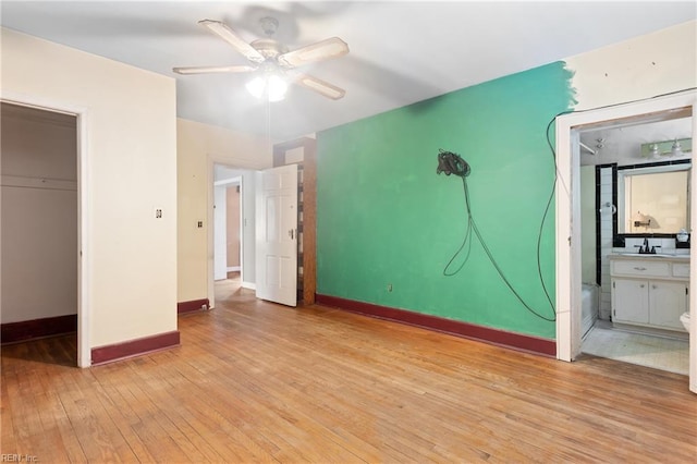 1040 Poquoson Ave, Poquoson, VA 23662 - unfurnished bedroom featuring light wood finished floors, baseboards, a sink, ceiling fan, and ensuite bathroom