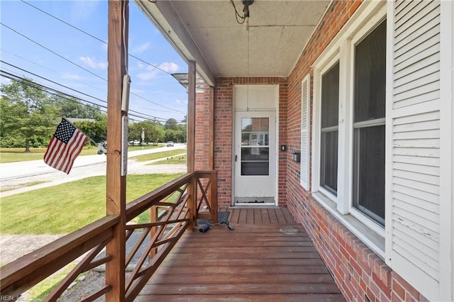1040 Poquoson Ave, Poquoson, VA 23662 - wooden porch featuring a lawn