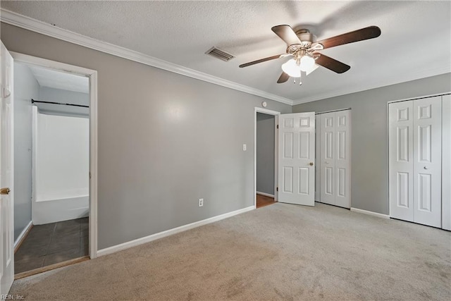915 Spinnaker Ct, Chesapeake, VA 23320 - unfurnished bedroom featuring carpet, multiple closets, baseboards, and crown molding