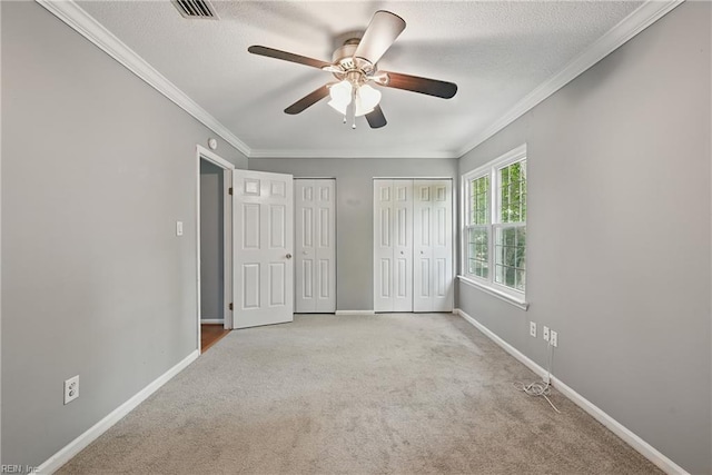 915 Spinnaker Ct, Chesapeake, VA 23320 - unfurnished bedroom featuring multiple closets, carpet floors, baseboards, ornamental molding, and a textured ceiling