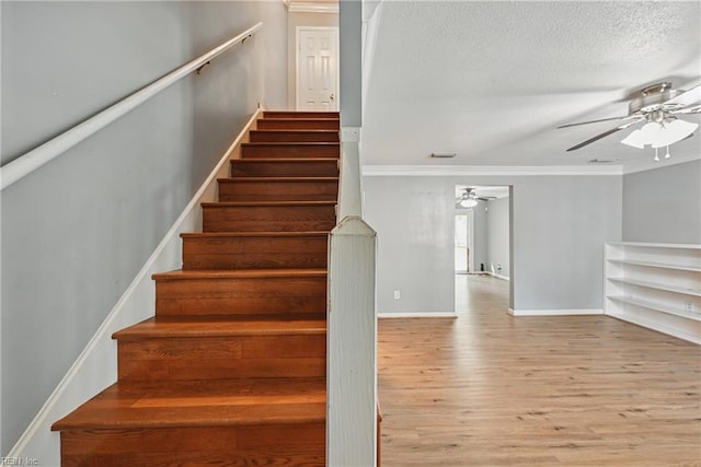 915 Spinnaker Ct, Chesapeake, VA 23320 - staircase featuring a ceiling fan, wood finished floors, ornamental molding, a textured ceiling, and baseboards