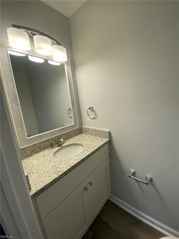 711 Vellines Ave, Chesapeake, VA 23324 - bathroom with vanity, wood finished floors, and baseboards