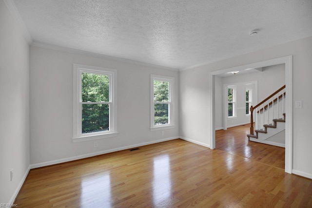 105 Londonderry Ln, Williamsburg, VA 23188 - unfurnished room with plenty of natural light, a textured ceiling, stairway, wood finished floors, and ornamental molding