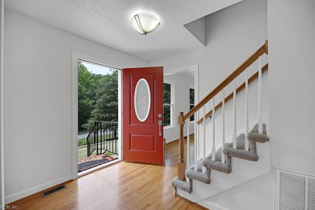 105 Londonderry Ln, Williamsburg, VA 23188 - foyer featuring wood finished floors, stairs, a textured ceiling, and baseboards
