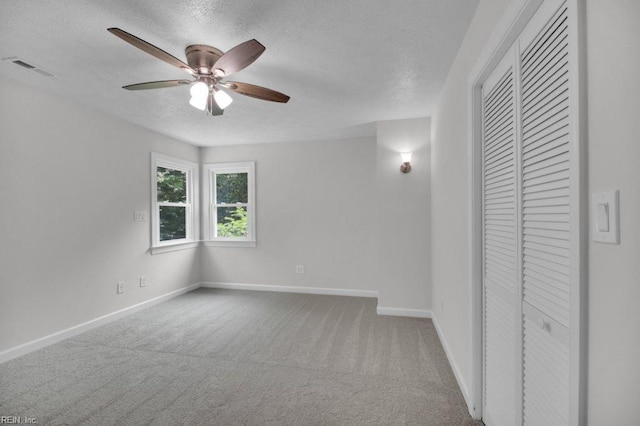 105 Londonderry Ln, Williamsburg, VA 23188 - unfurnished bedroom with a closet, a textured ceiling, carpet, and baseboards