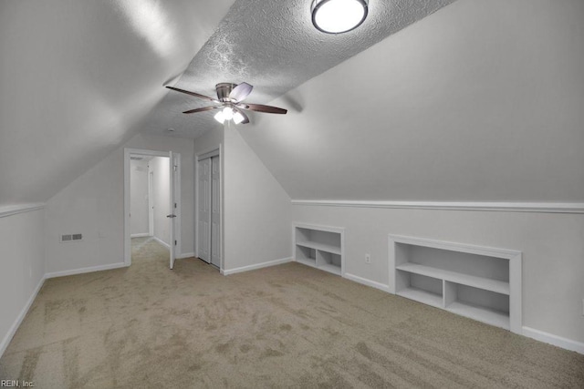 105 Londonderry Ln, Williamsburg, VA 23188 - bonus room featuring built in shelves, a textured ceiling, ceiling fan, carpet floors, and lofted ceiling
