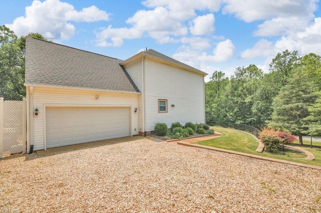 105 Londonderry Ln, Williamsburg, VA 23188 - view of side of property with driveway, a garage, and a shingled roof
