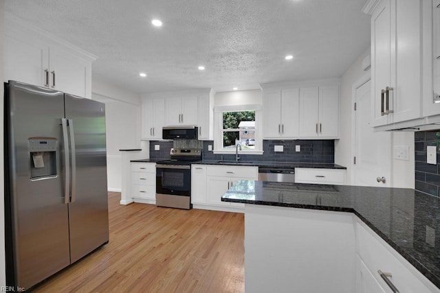 105 Londonderry Ln, Williamsburg, VA 23188 - kitchen with stainless steel appliances, a sink, white cabinets, tasteful backsplash, and recessed lighting