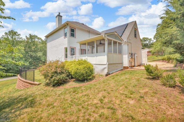 105 Londonderry Ln, Williamsburg, VA 23188 - rear view of house featuring a sunroom, a ceiling fan, a chimney, and a yard