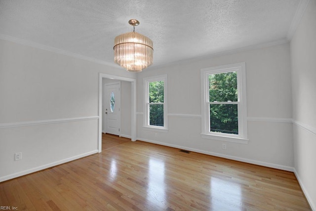 105 Londonderry Ln, Williamsburg, VA 23188 - empty room with a textured ceiling, a chandelier, wood finished floors, baseboards, and crown molding