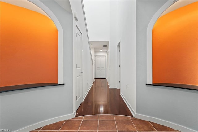 3738 Sandpiper Rd Unit 413, Virginia Beach, VA 23456 - hall featuring baseboards, arched walkways, and tile patterned flooring