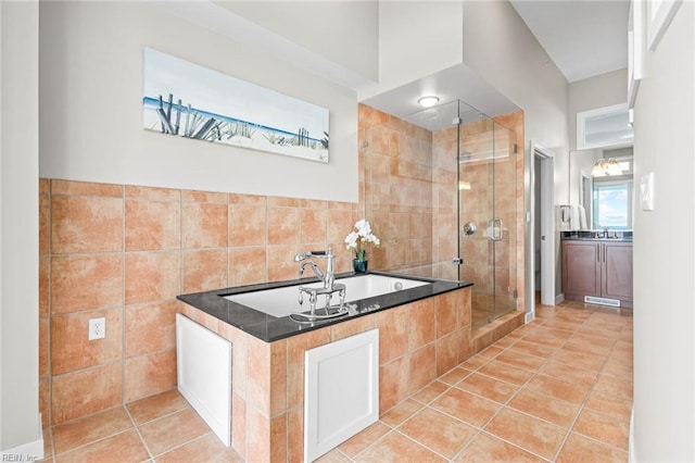 3738 Sandpiper Rd Unit 413, Virginia Beach, VA 23456 - bathroom with a stall shower, a garden tub, tile patterned floors, tile walls, and vanity
