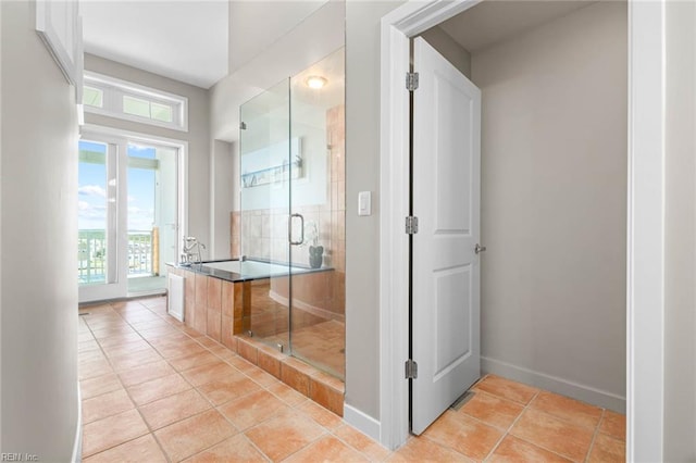 3738 Sandpiper Rd Unit 413, Virginia Beach, VA 23456 - bathroom with a shower stall, tile patterned flooring, a garden tub, and baseboards