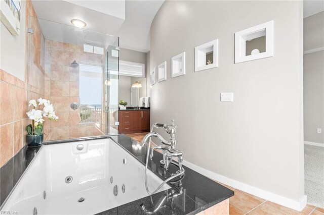 3738 Sandpiper Rd Unit 413, Virginia Beach, VA 23456 - full bath featuring a jetted tub, tiled shower, baseboards, and vanity