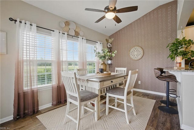 2685 Robert Monette Ln, Virginia Beach, VA 23456 - dining space featuring wallpapered walls, an accent wall, baseboards, wood finished floors, and plenty of natural light