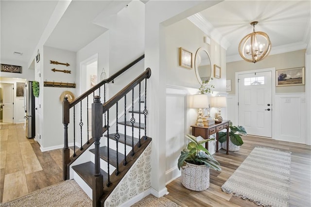 2685 Robert Monette Ln, Virginia Beach, VA 23456 - entryway featuring a chandelier, ornamental molding, wood finished floors, and stairs