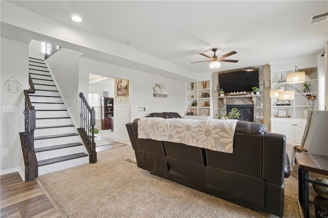 2685 Robert Monette Ln, Virginia Beach, VA 23456 - living area with ceiling fan, a stone fireplace, stairway, wood finished floors, and baseboards