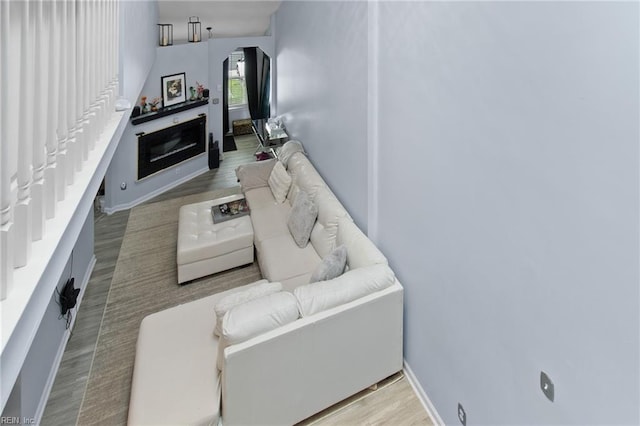 686 Aylesbury Dr, Virginia Beach, VA 23462 - living area with baseboards, a glass covered fireplace, wood finished floors, and arched walkways