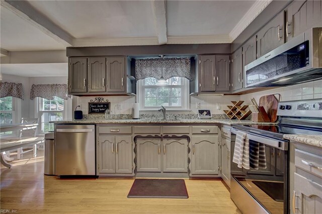 405 Bartell Dr, Chesapeake, VA 23322 - kitchen featuring stainless steel appliances, backsplash, light wood-type flooring, crown molding, and beam ceiling