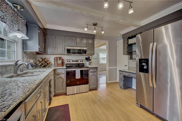405 Bartell Dr, Chesapeake, VA 23322 - kitchen featuring stainless steel appliances, a sink, light wood-style floors, ornamental molding, and light stone countertops