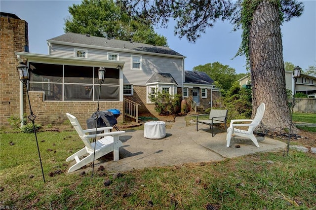 405 Bartell Dr, Chesapeake, VA 23322 - rear view of property featuring a sunroom, a patio area, brick siding, and a yard