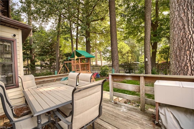 1 Smith St, Poquoson, VA 23662 - deck featuring a playground, outdoor dining space, and view of scattered trees
