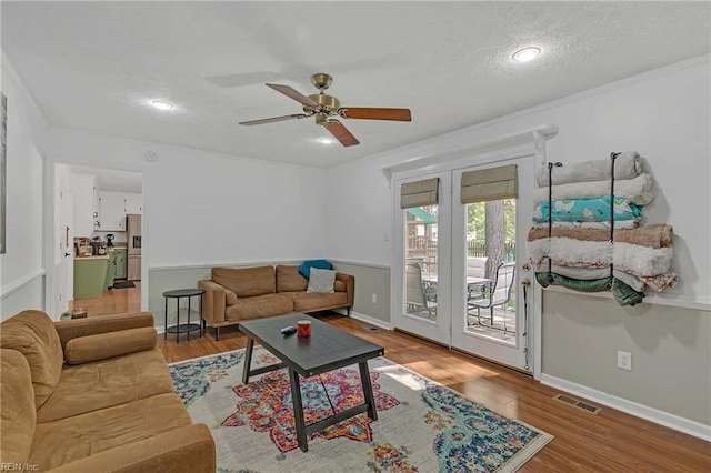 1 Smith St, Poquoson, VA 23662 - living room with ceiling fan, wood finished floors, baseboards, and a textured ceiling