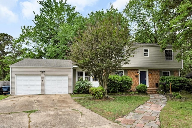 401 Kings Point Rd, Virginia Beach, VA 23452 - view of front of house featuring concrete driveway, a garage, brick siding, and a front lawn