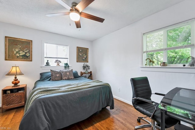 401 Kings Point Rd, Virginia Beach, VA 23452 - bedroom featuring multiple windows, wood finished floors, baseboards, and a ceiling fan