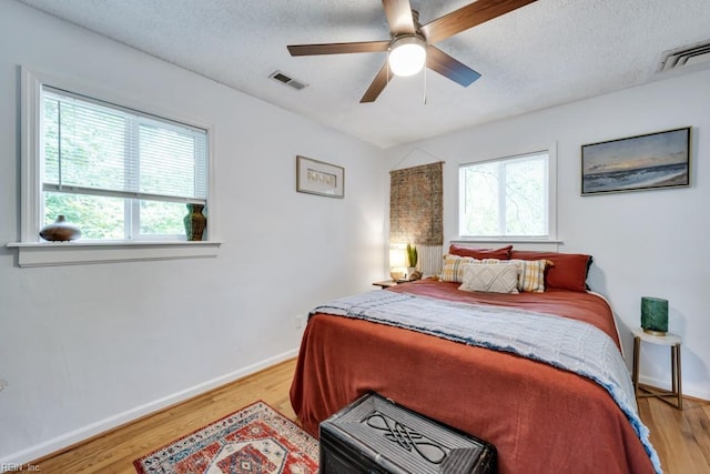 401 Kings Point Rd, Virginia Beach, VA 23452 - bedroom featuring baseboards, light wood finished floors, a textured ceiling, and a ceiling fan