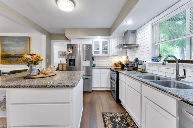 401 Kings Point Rd, Virginia Beach, VA 23452 - kitchen with stainless steel appliances, wall chimney exhaust hood, a sink, decorative backsplash, and white cabinets