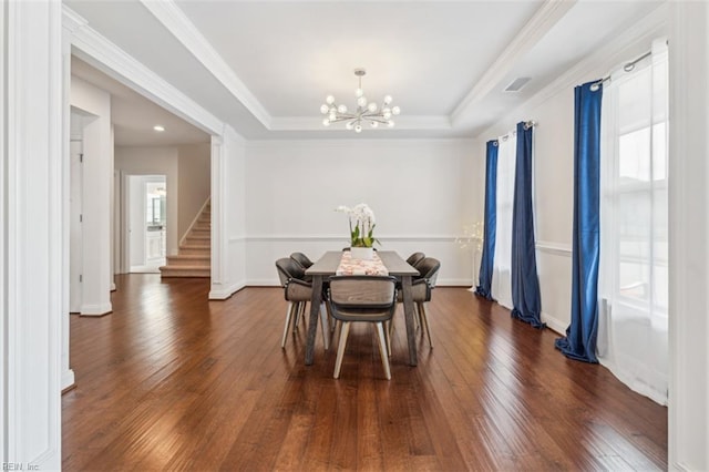 1652 Teton Ct, Chesapeake, VA 23320 - dining space featuring dark wood-style floors, a chandelier, stairs, a raised ceiling, and ornamental molding