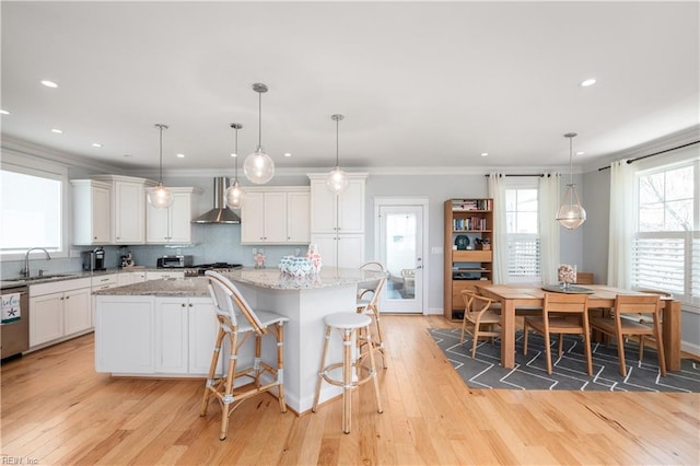 120 55th 1/2 St, Virginia Beach, VA 23451 - kitchen with wall chimney exhaust hood, a sink, a kitchen island, light wood-style flooring, and white cabinetry
