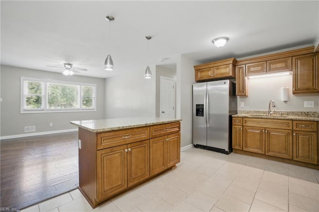 2613 Cedar Rd, Chesapeake, VA 23323 - kitchen with stainless steel refrigerator with ice dispenser, a sink, a ceiling fan, and brown cabinets