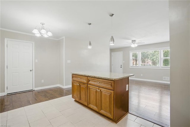 2613 Cedar Rd, Chesapeake, VA 23323 - kitchen with brown cabinets, light wood-type flooring, hanging light fixtures, a chandelier, and a ceiling fan