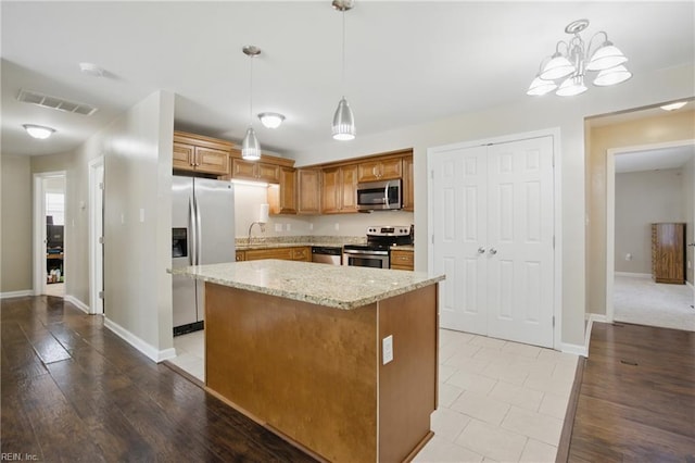 2613 Cedar Rd, Chesapeake, VA 23323 - kitchen with appliances with stainless steel finishes, light stone counters, baseboards, and a center island