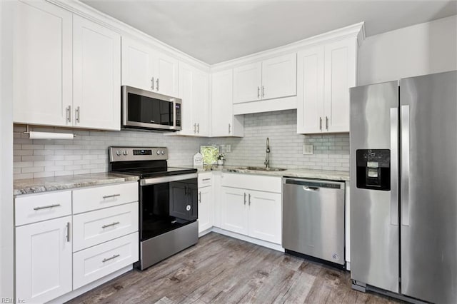 3054 Comte Ct, Virginia Beach, VA 23453 - kitchen featuring stainless steel appliances, a sink, white cabinets, light stone countertops, and dark wood finished floors