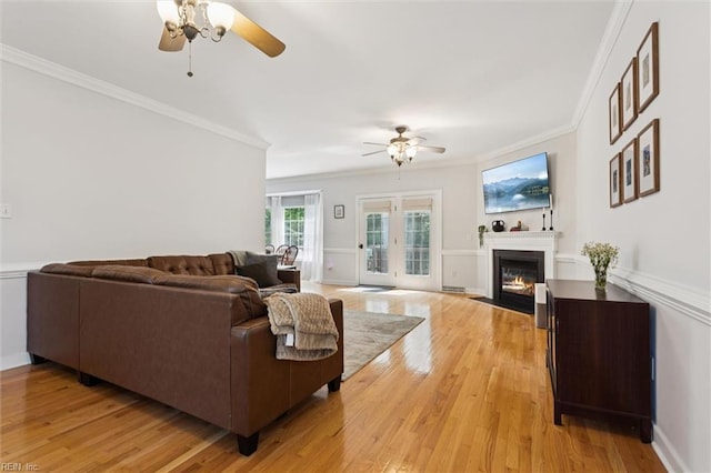 5891 Chaucer Dr, Providence Forge, VA 23140 - living room featuring a ceiling fan, crown molding, a fireplace with flush hearth, and light wood-style flooring