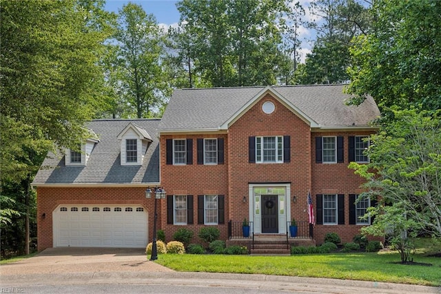 5891 Chaucer Dr, Providence Forge, VA 23140 - colonial-style house featuring an attached garage, driveway, brick siding, and a front lawn