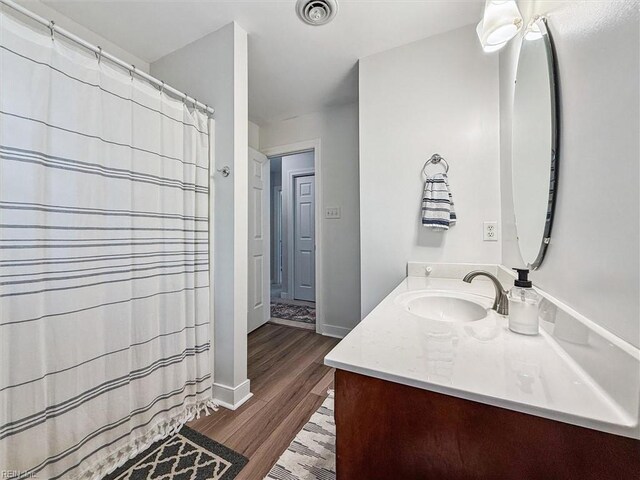 5891 Chaucer Dr, Providence Forge, VA 23140 - full bathroom featuring vanity, wood finished floors, baseboards, and a shower with shower curtain