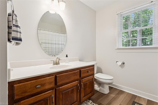 5891 Chaucer Dr, Providence Forge, VA 23140 - bathroom with vanity, wood finished floors, toilet, and baseboards