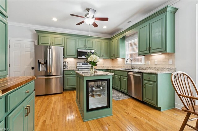5891 Chaucer Dr, Providence Forge, VA 23140 - kitchen featuring stainless steel appliances, green cabinetry, a sink, crown molding, and a ceiling fan