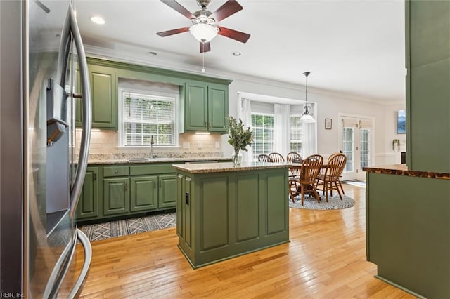5891 Chaucer Dr, Providence Forge, VA 23140 - kitchen with green cabinets, stainless steel fridge, a sink, tasteful backsplash, and ornamental molding