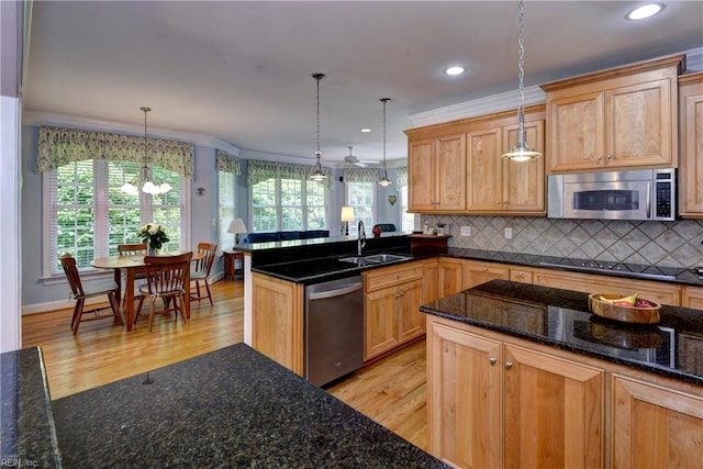 200 Cruden Bay, Williamsburg, VA 23188 - kitchen featuring appliances with stainless steel finishes, a sink, light wood-style floors, a chandelier, and healthy amount of natural light