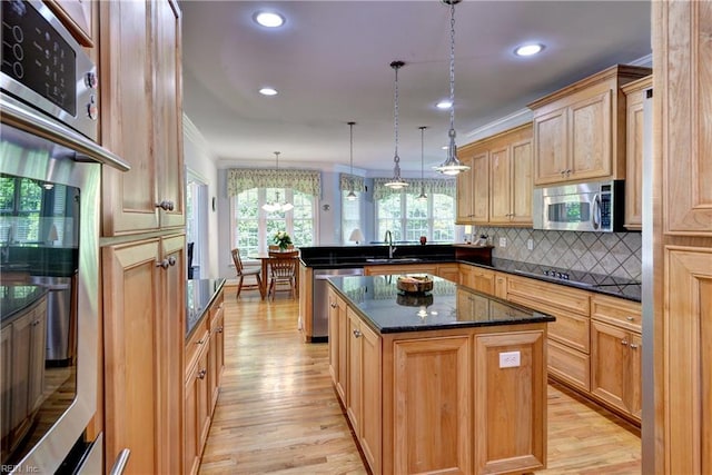 200 Cruden Bay, Williamsburg, VA 23188 - kitchen with stainless steel appliances, a peninsula, light wood finished floors, backsplash, and crown molding