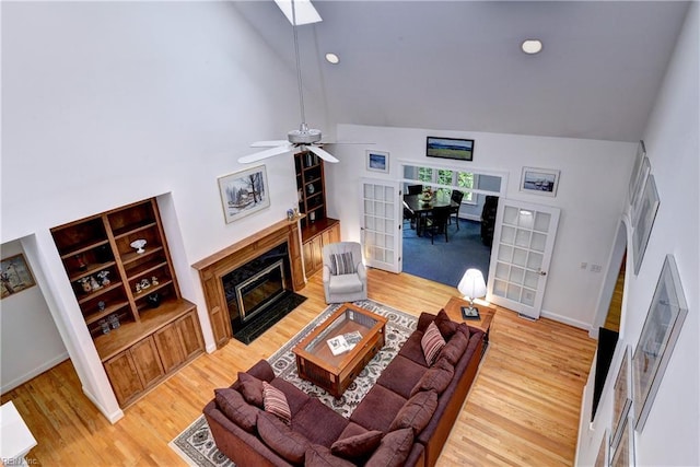 200 Cruden Bay, Williamsburg, VA 23188 - living area with wood finished floors, a fireplace with flush hearth, high vaulted ceiling, a ceiling fan, and a skylight