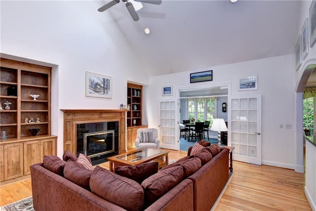 200 Cruden Bay, Williamsburg, VA 23188 - living room featuring high vaulted ceiling, arched walkways, a ceiling fan, a fireplace, and light wood-style flooring