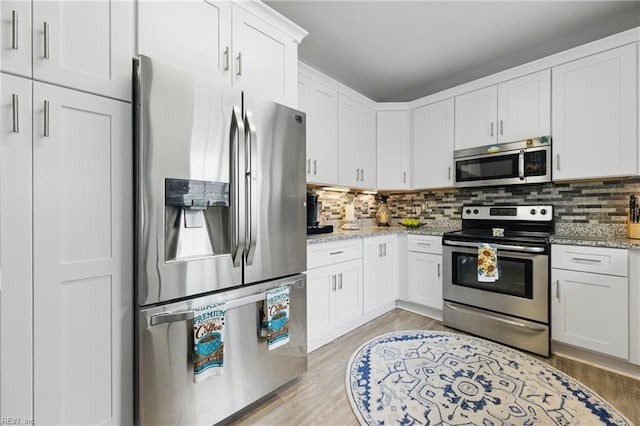 13435 Prince Andrew Trl, Carrollton, VA 23314 - kitchen with appliances with stainless steel finishes, backsplash, light stone counters, and white cabinets