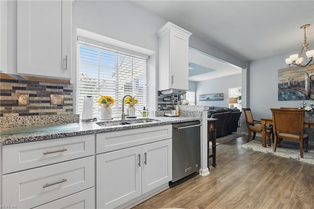 13435 Prince Andrew Trl, Carrollton, VA 23314 - kitchen featuring stainless steel dishwasher, a sink, light wood-type flooring, a chandelier, and tasteful backsplash